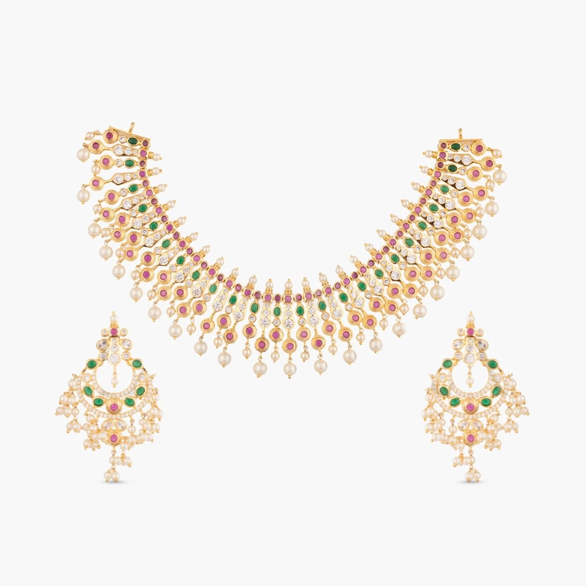A picture of Indian artificial jewelry. It is a gold plated necklace set with earrings featuring pearls and green and red gemstones.