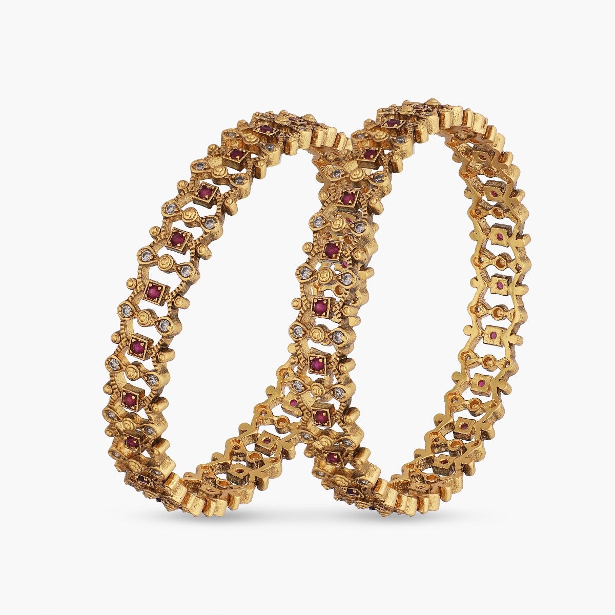 A picture of Indian artificial jewelry: a pair of gold-colored bangles with red and Cubic zirconia stones on a white background.