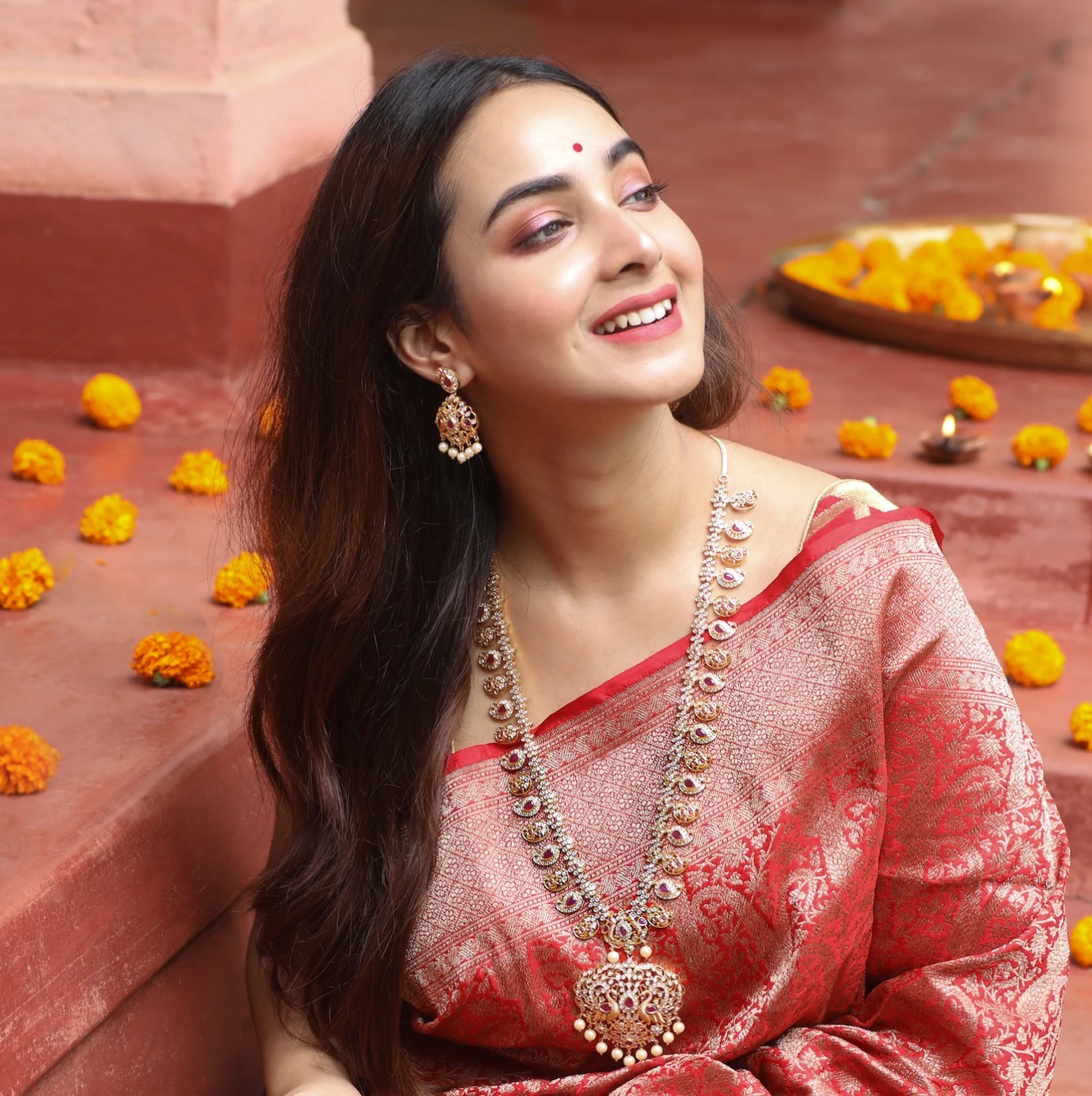 Sabyasachi - The lady wears a Benarasi organza saree with embroidered  borders and a Benarasi tissue blouse. The saree is paired with the Bengal  Tiger duet in 18k gold, studded with pearls